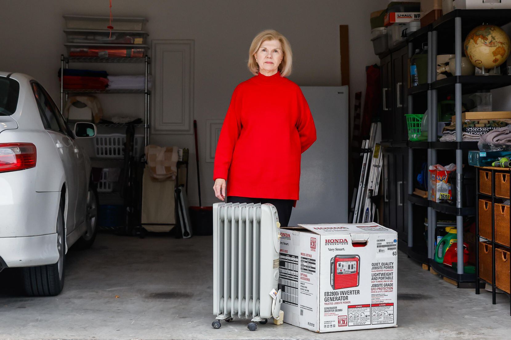 Leslie Jagger poses next to a heater and a generator at her garage in Garland on Feb. 2,...
