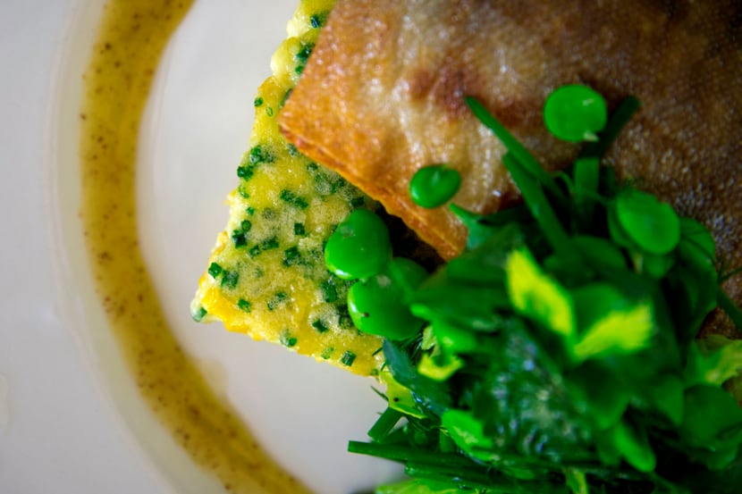 Arctic char with a corn pudding and fava herb salad at Cafe Momentum, photographed Tuesday,...