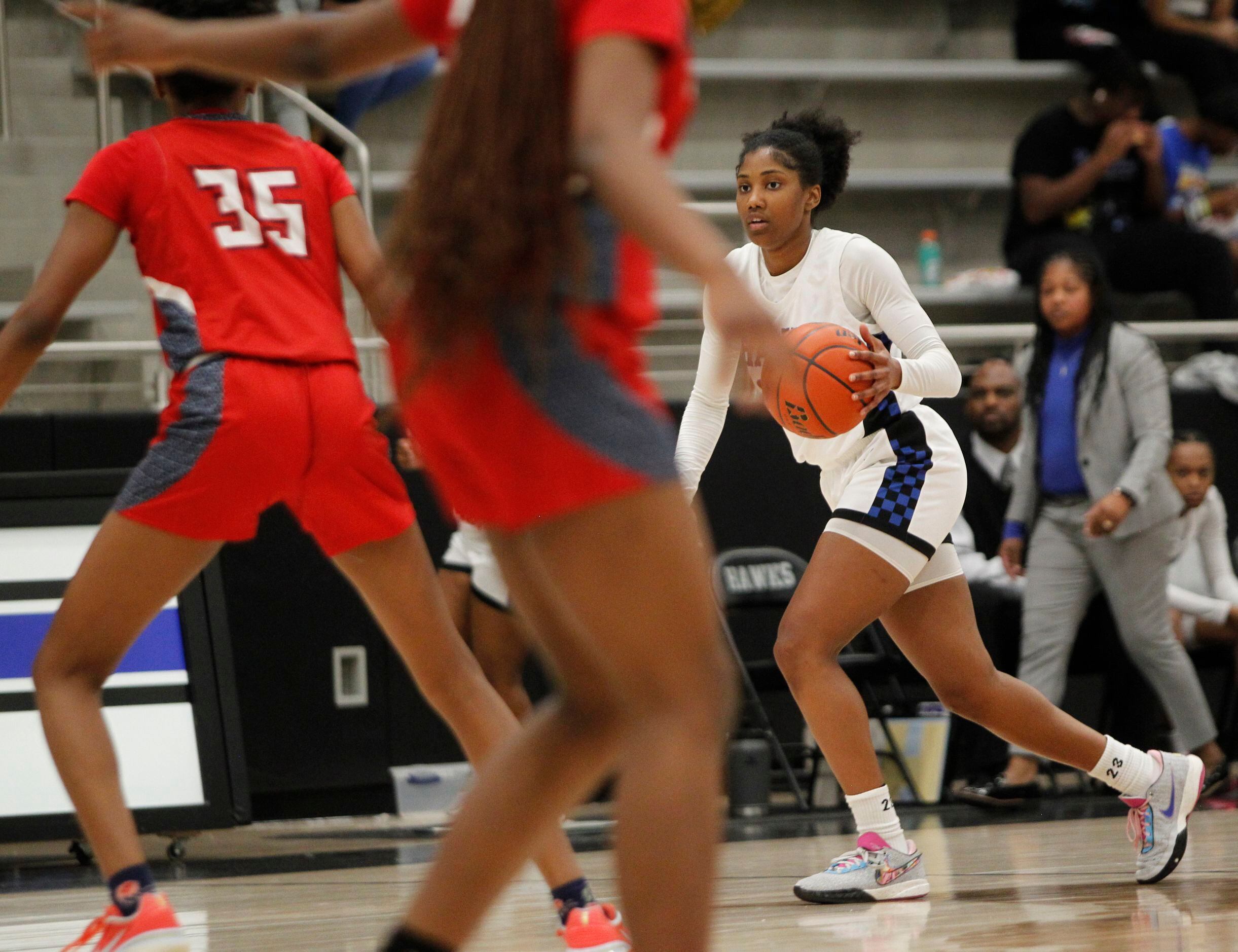 Hebron guard Paris Bradley (23), right, brings the ball past mid-court during first half...