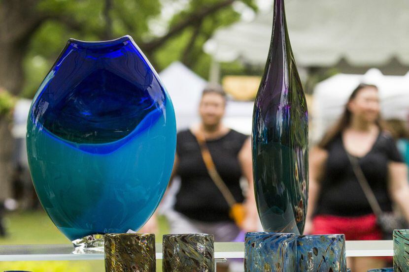Visitors pass glasswork by artist Jim Bowman at Artscape, the annual fine art show and sale...