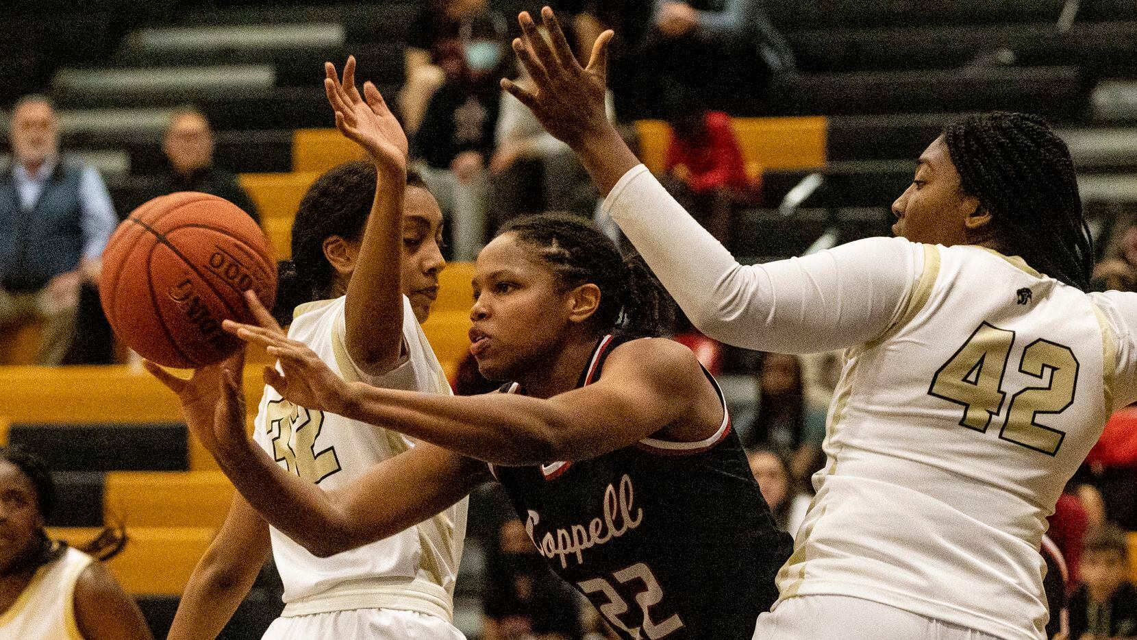 Coppell's India Howard (22) is surrounded by Plano East defenders during Plano East's 42-37...