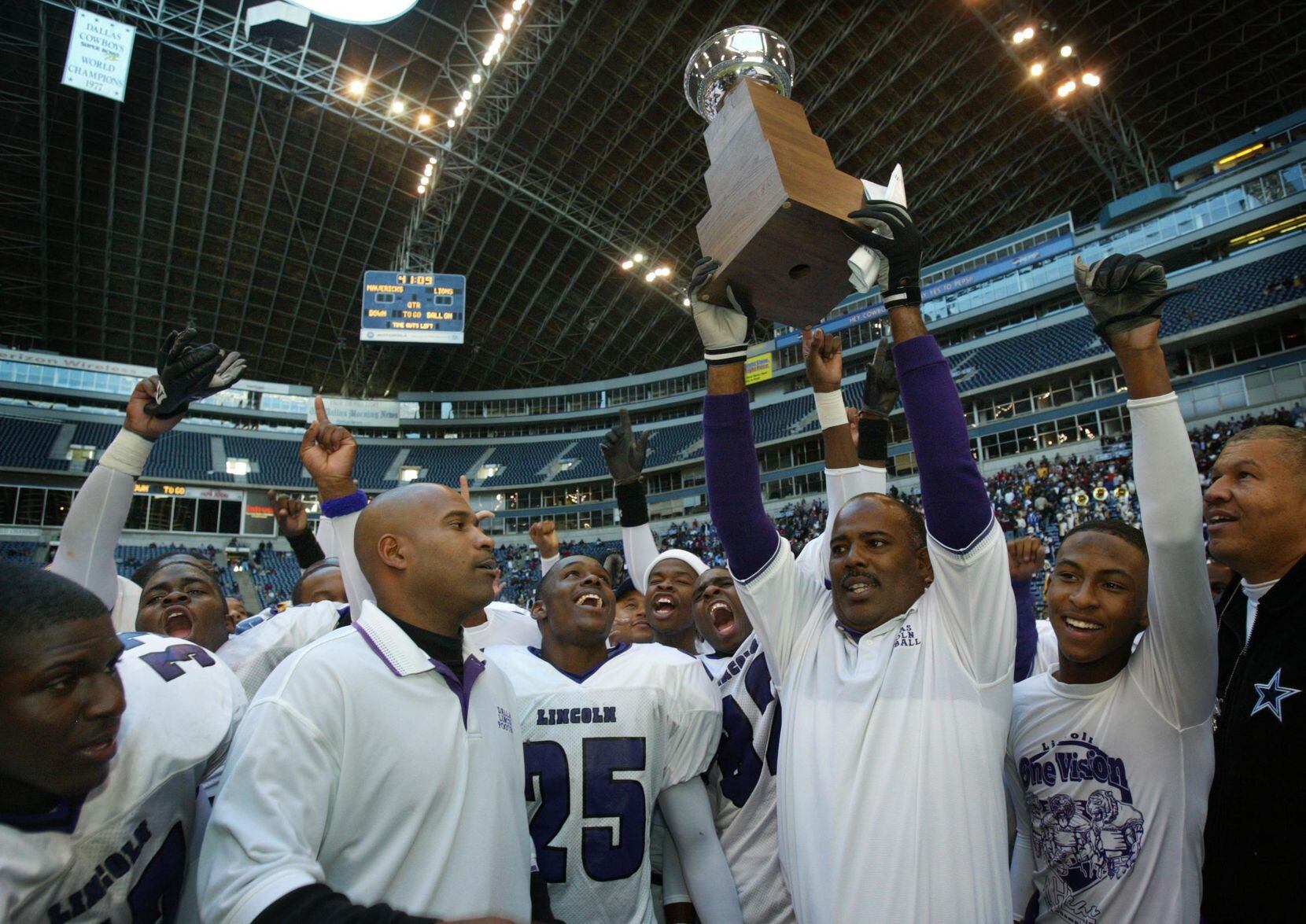 FILE: Former Dallas Lincoln High coach Reginald Samples (with trophy) and assistants and...
