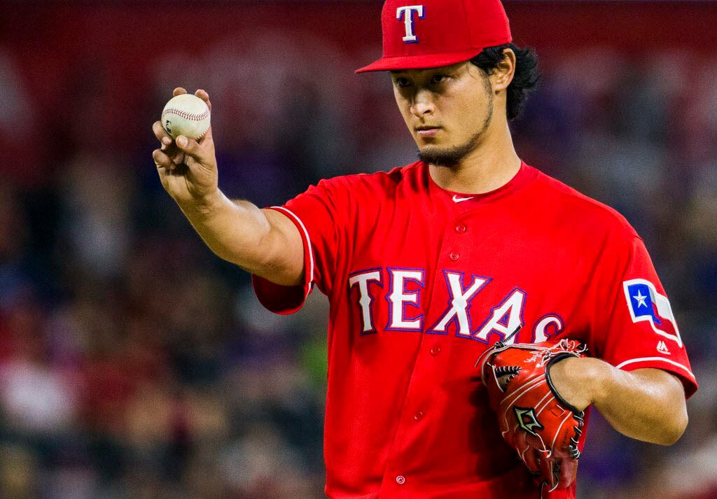 Texas Rangers starting pitcher Yu Darvish (11) lines up the ball during the sixth inning of...