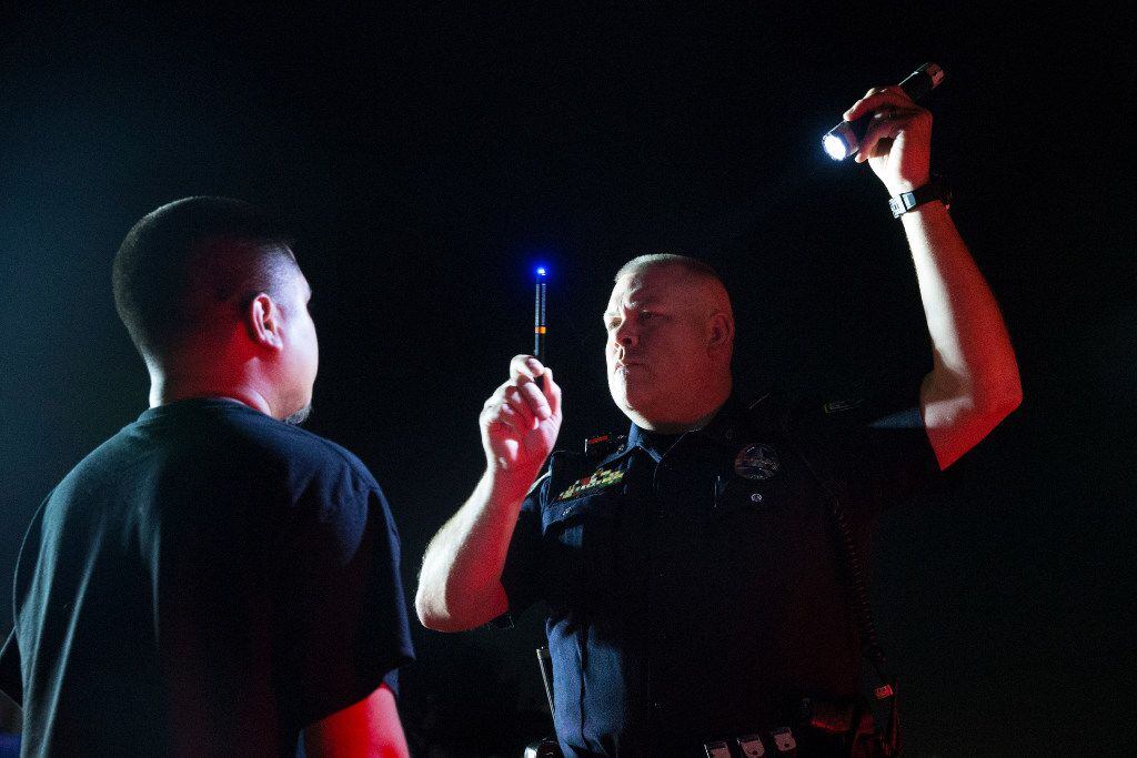 Irving Police Office Stephen Burres III gives a field sobriety test during a DWI stop in...
