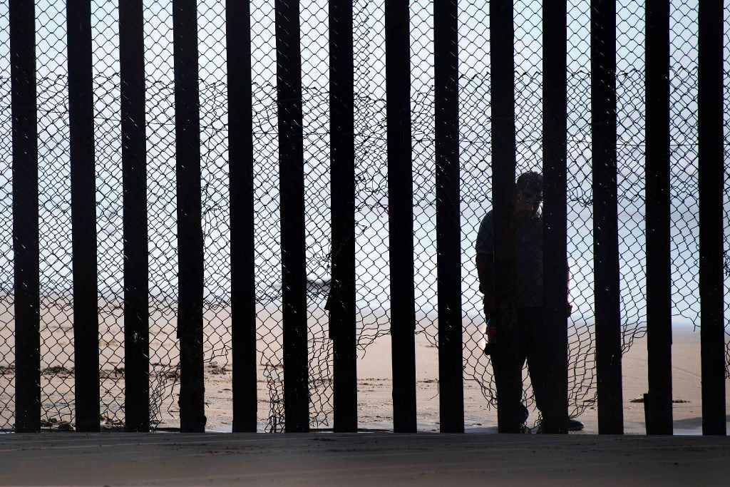 This file photo taken on February 13, 2017 shows  a man standing on the Mexico side of a...