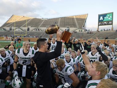 Southlake head coach Riley Dodge holds up the Region I trophy after they defeated Allen...