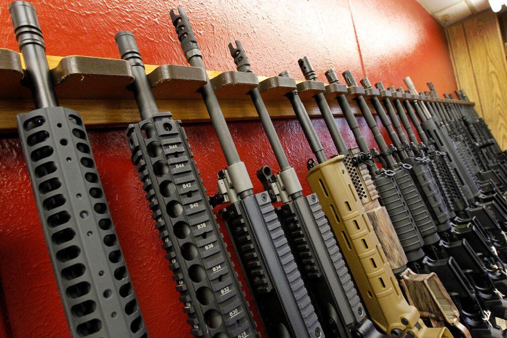 In this July 20, 2012, file photo, a row of different AR-15 style rifles are displayed for...