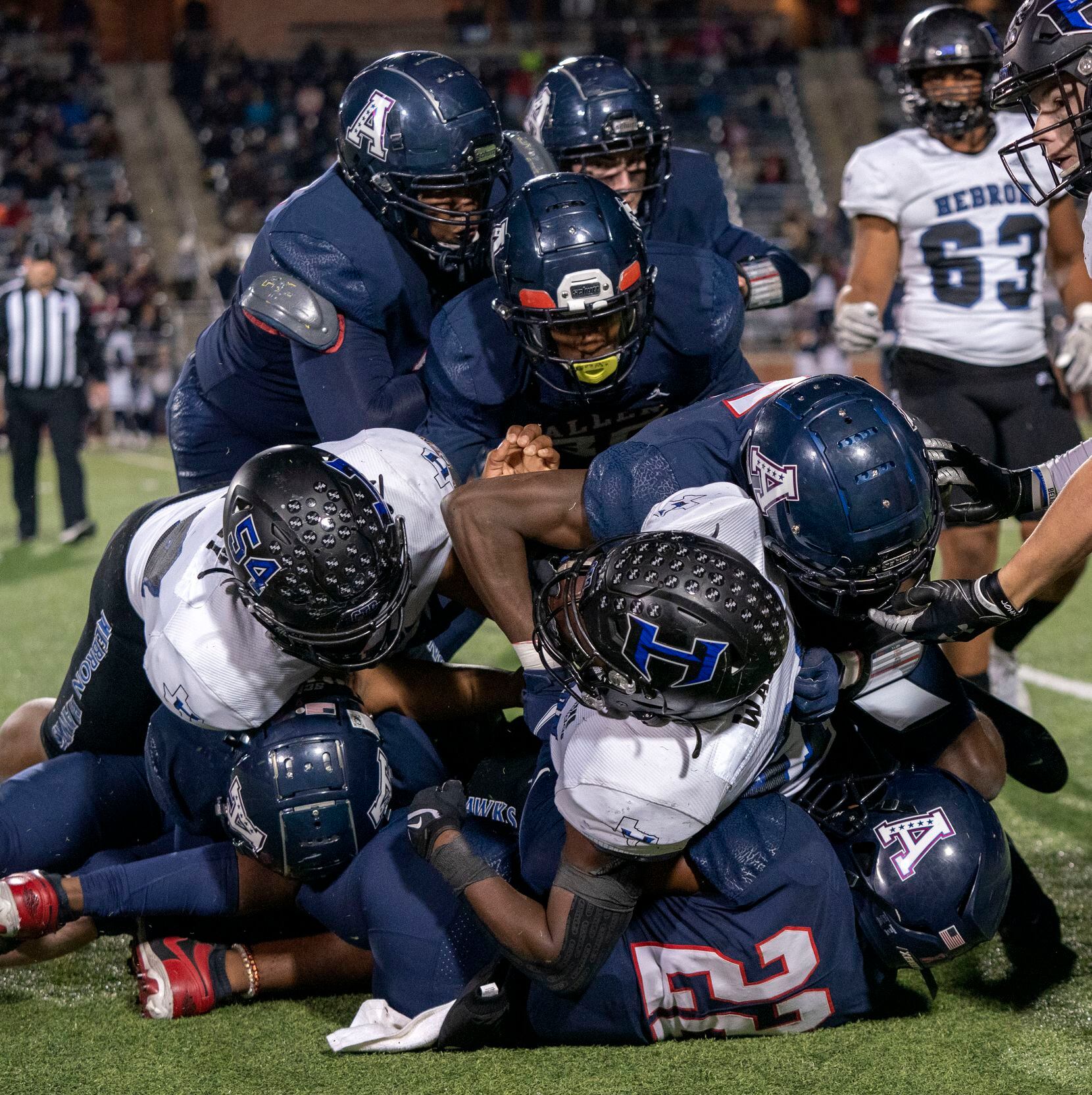 Hebron running back is brought down by a horde of Allen defenders during the first half of a...