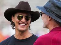 Actor Matthew McConaughey talks with former Oklahoma player and Irving native Brian Bosworth...