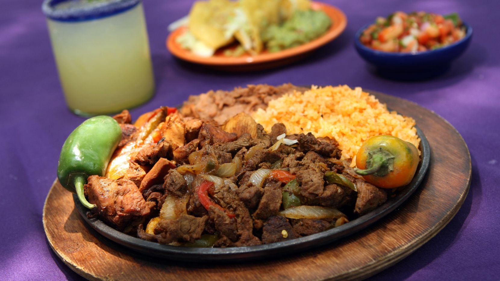 A margarita and a plate of Tex-Mex on the patio at Joe T. Garcia's in Fort Worth: That's a...