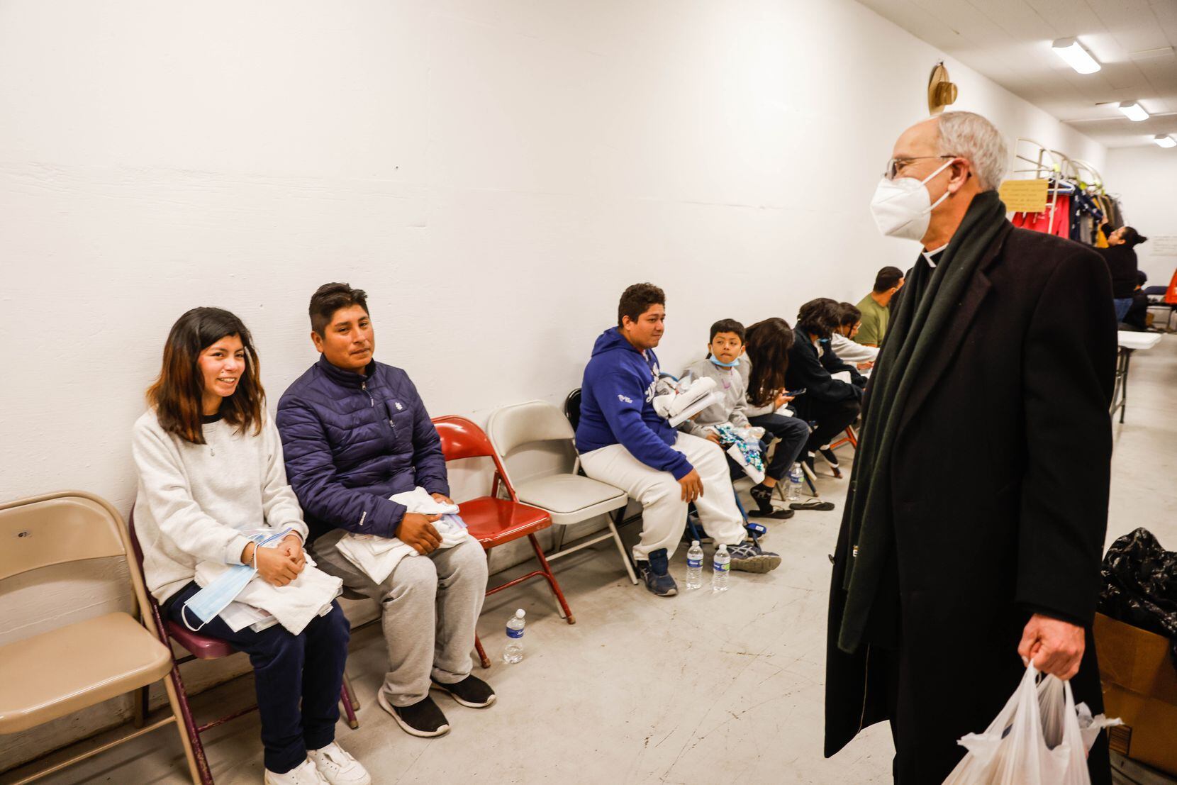 Bishop Mark Seitz talks with Alex and his daughter Yaritza, 15, both from Peru, about their...