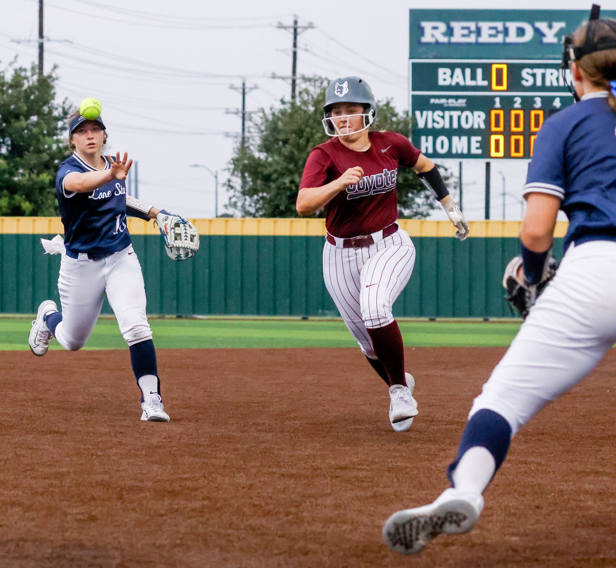 Frisco Lone Star shortstop Emilee Prochaska (10, left) throws the ball in an attempt to get...