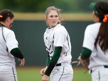 Prosper's Elizabeth Moffitt, center, looks on before game one of a best of three series of a...