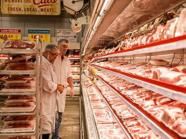 H-E-B worker checks the meats section at the new store that opened its door to public at 6AM...