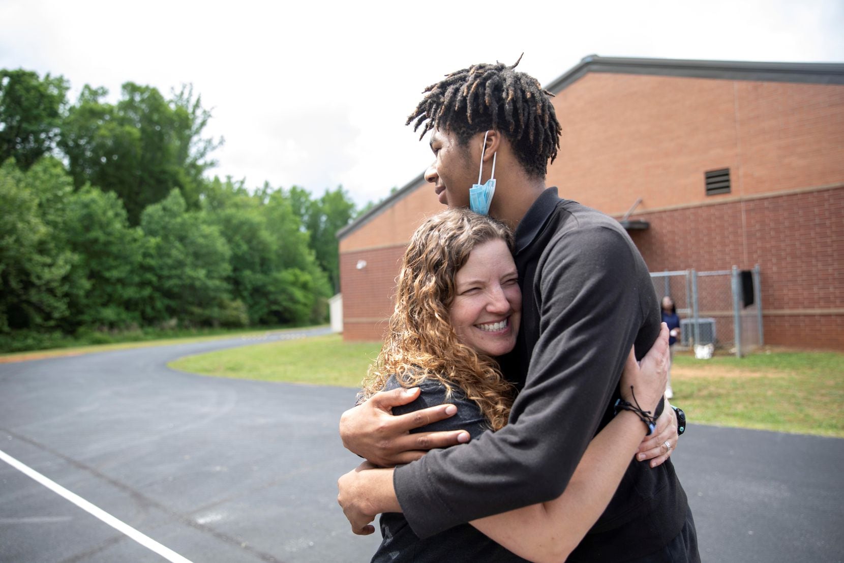 Christina Cody, health and wellness specialist, is greeted by student Shane Davidson at...