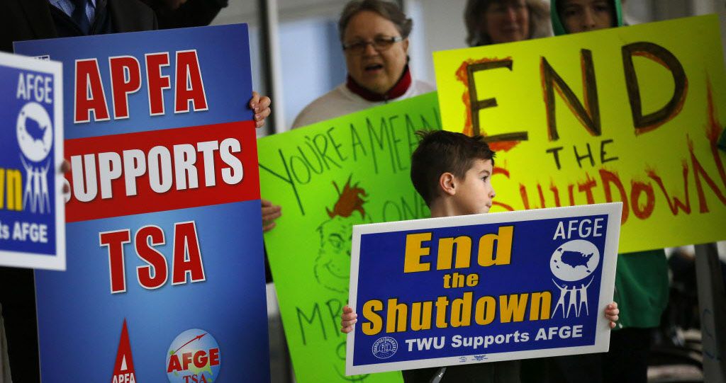 Airport employees and their families protest the government shutdown on Jan. 16 outside of...