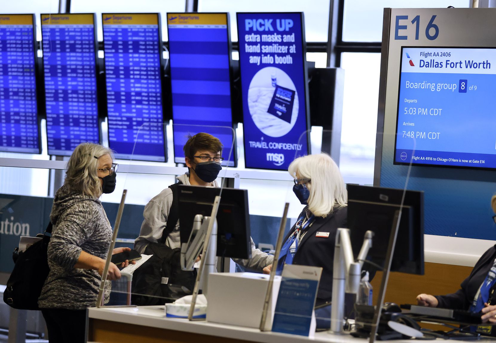 American Airlines passengers board a flight to DFW Airport from Terminal E at Minneapolis...