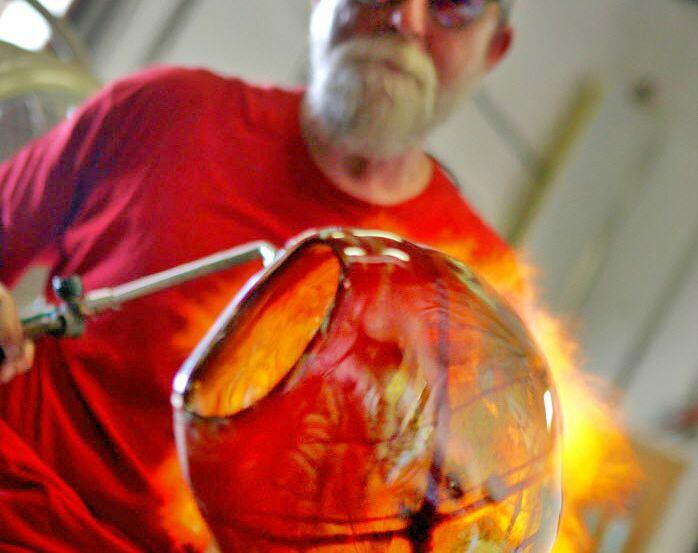 Jim Bowman at work in his Bowman Glass Studio in The Cedars. 