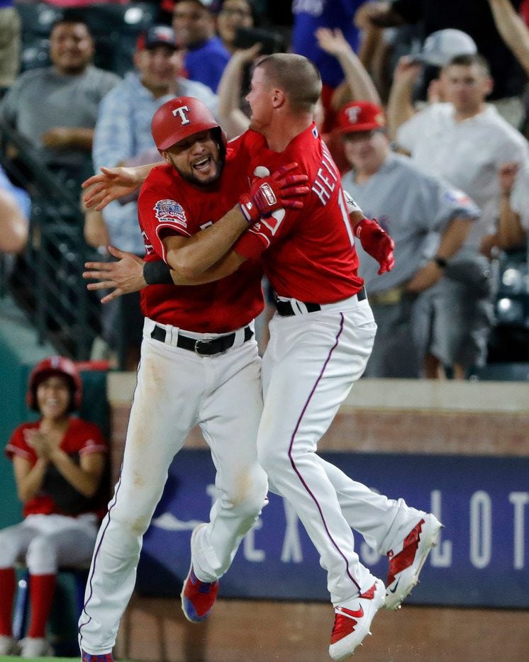 Texas Rangers' Isiah Kiner-Falefa (9) and Scott Heinemann celebrate after Kiner-Falefa hit a run-scoring single in the 11th inning of a baseball game against the Los Angeles Angels in Arlington, Texas, Monday, Aug. 19, 2019. The Rangers won 8-7. (AP Photo/Tony Gutierrez)