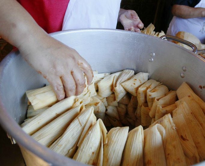 Tamales are placed in the cooking pot at Luna's Tortilla Factory.