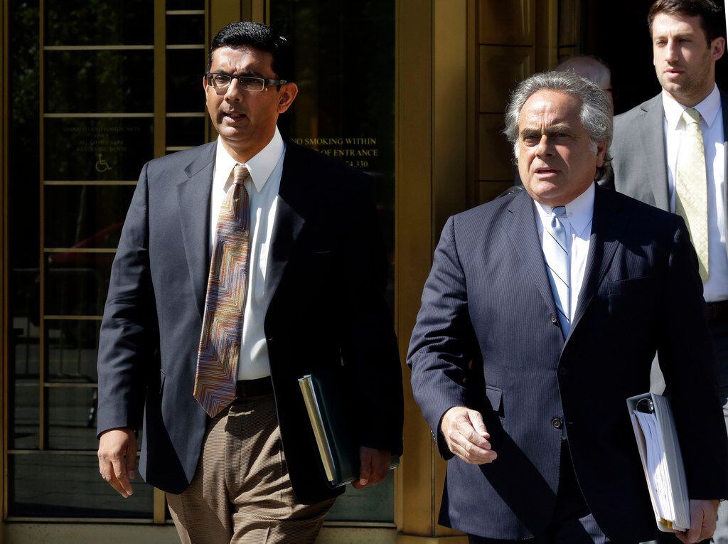 Conservative commentator and filmmaker Dinesh D'Souza (left),  accompanied by his lawyer,...