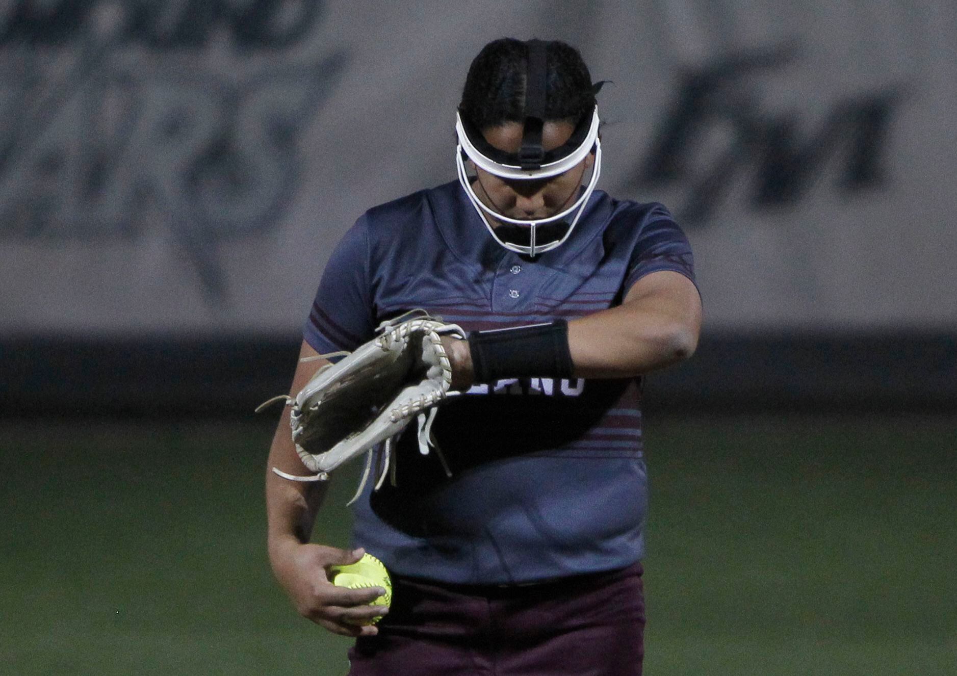 Plano pitcher Jayden Bluitt (20) verifies a sign before delivering a pitch to a Flower Mound...