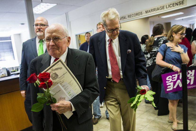 George Harris, 82, and Jack Evans, 85, hold their marriage license on Friday, June 26, 2015...