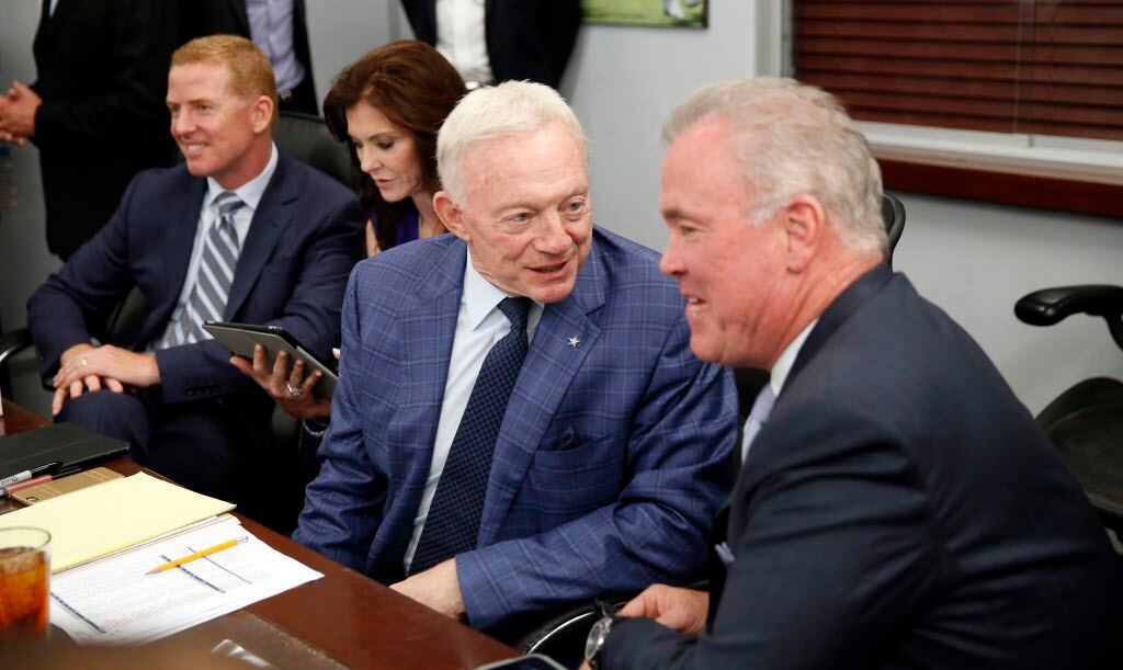 Dallas Cowboys owner Jerry Jones (second from right) visits with his son Stephen Jones...