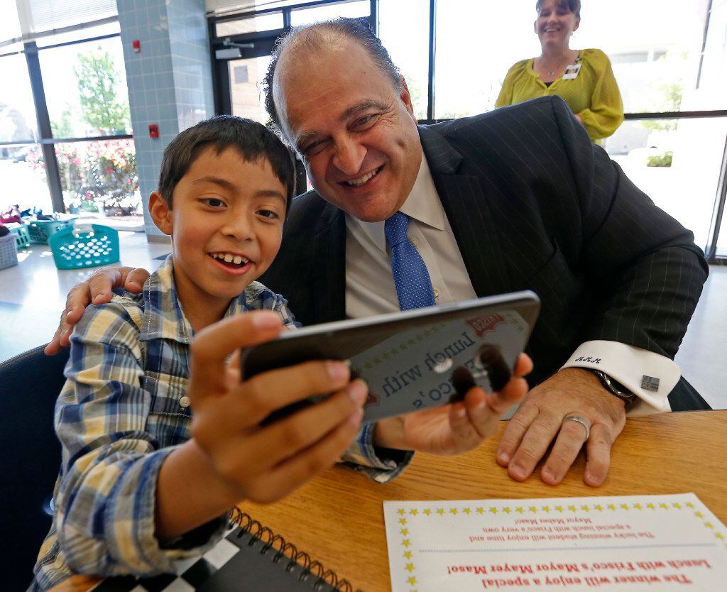 Mayor Maher Maso and second-grader Ian Bolanos, 8, take a selfie while having lunch together...