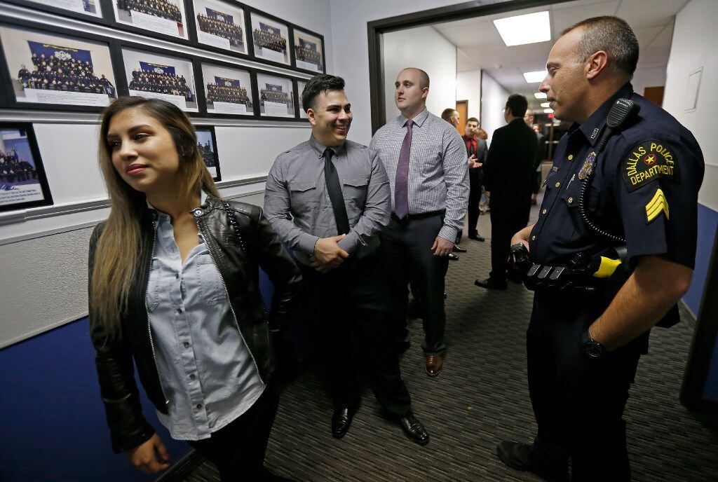 Training coordinator Sgt. Richard Foy (right) talks with recruit Kevin Baez (second from...