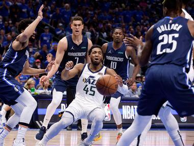 Utah Jazz guard Donovan Mitchell (45) finds himself surrounded by the Dallas Mavericks...