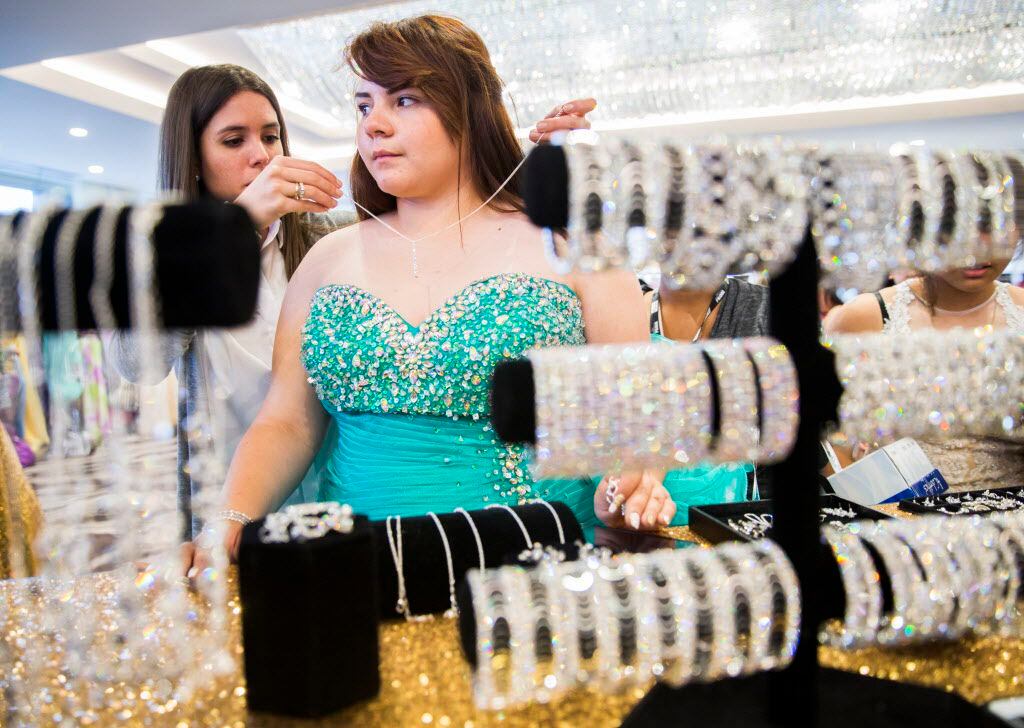 H. Grady Spruce High school student, Cristal Martinez, 17, tries on jewelry to go with her...