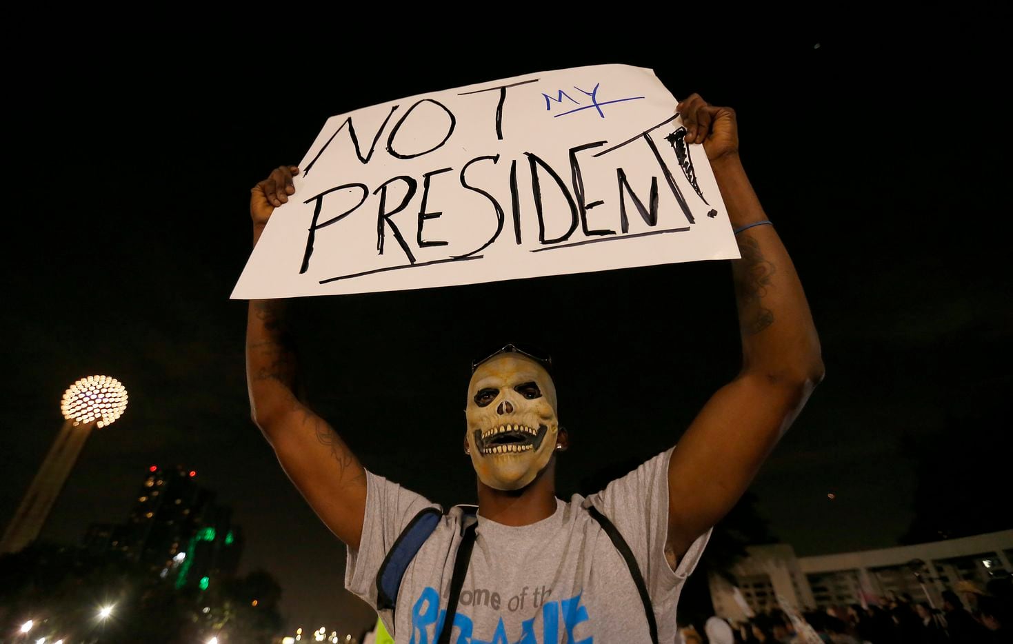 R.J. Nichols, a protester against President-elect Donald Trump, holds up a sign during a...