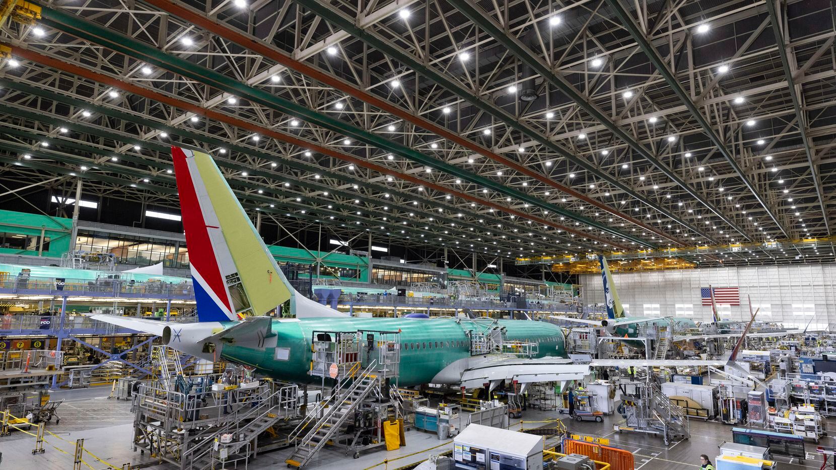Boeing employees work on the 737 MAX on the final assembly line at Boeing's Renton, Wash.,...