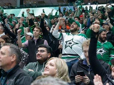 Dallas Stars fans celebrate a goal during the third period of an NHL game against the Ottawa...