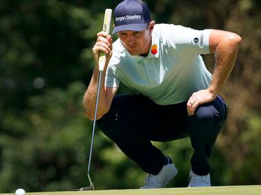 PGA Tour golfer Gary Woodland eyes his line as he putts on No. 8 during the second round of...