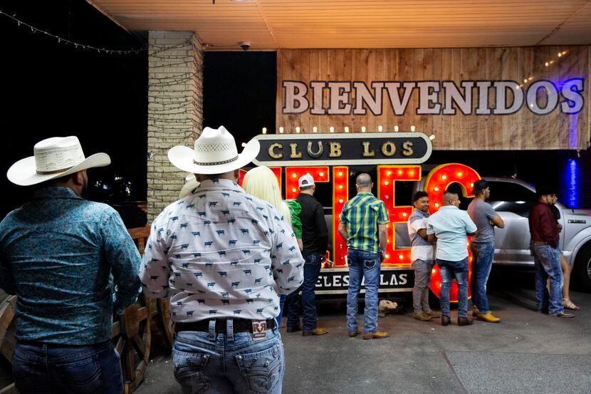 Patrons wait in line to enter Dallas' Club Los Rieles in mid-June. 
