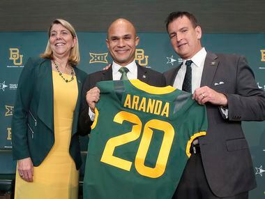 Baylor University Dr. Linda A. Livingstone, left, and Athletic Director Mack Rhoades, right, present new head football coach Dave Aranda, center, with a jersey during an during an NCAA college football news conference, Monday, Jan. 20, 2020, in Waco, Texas.