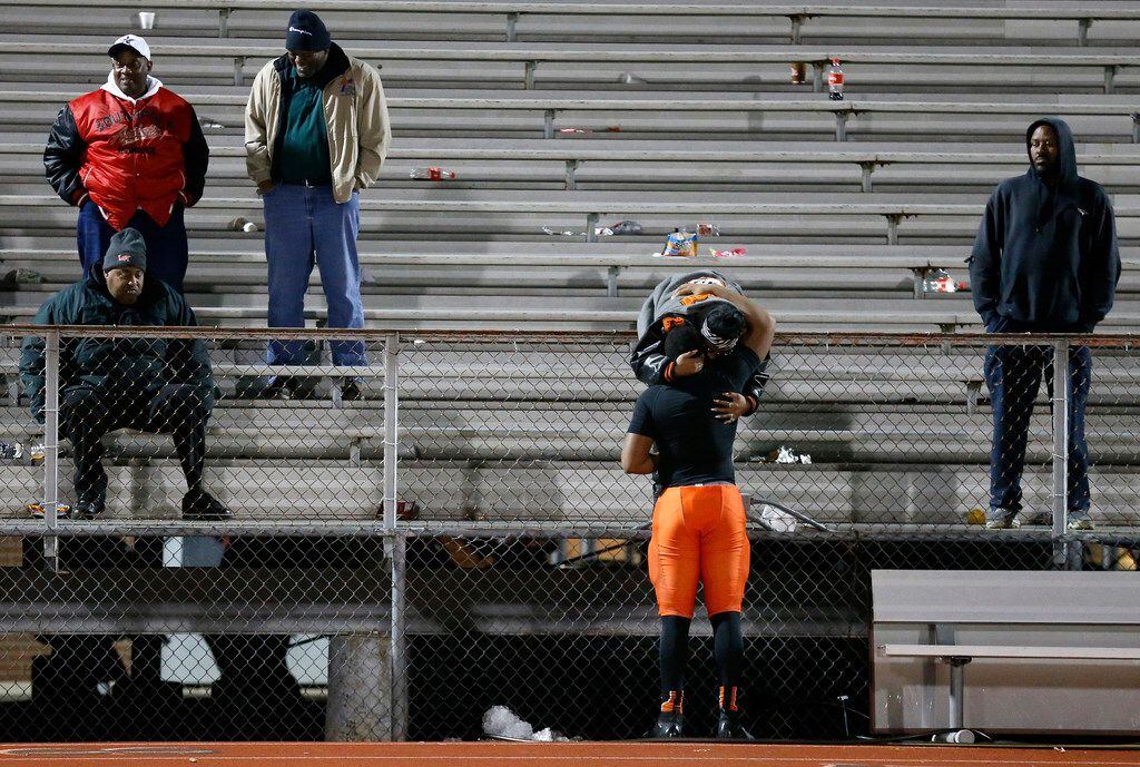 Lancaster defensive back Andre Dibbles Right) receives a hug following their loss too Frisco Lone Star in their Class 5A Division I Regional championship at Wilkerson-Sanders Stadium in Rockwall, Texas, Friday, December 6, 2019. (Tom Fox/The Dallas Morning News)