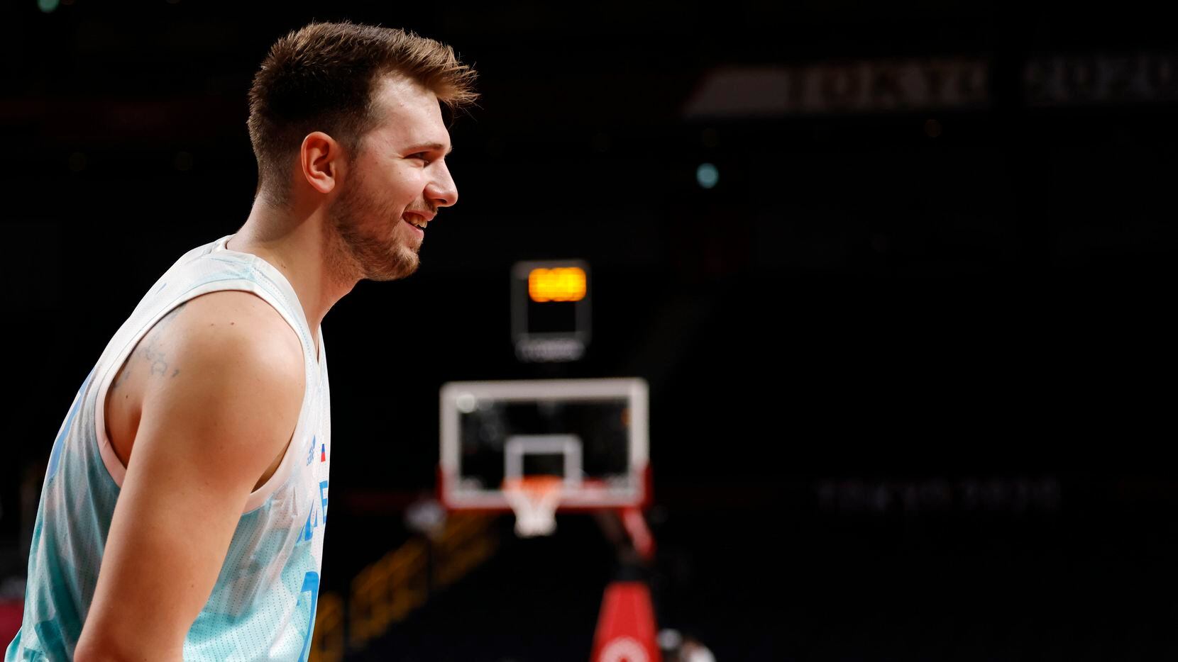 Slovenia’s Luka Doncic (77) smiles towards the bench in a basketball game against Japan...