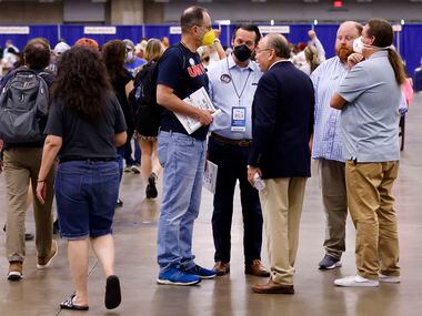 Texas Democratic Party Chairman Gilberto Hinojosa (third from right) visits with delegates...