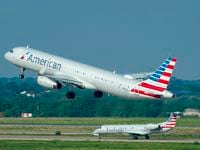 American Airlines planes are seen on takeoff and landing at DFW Airport on Monday, May 2, 2022.