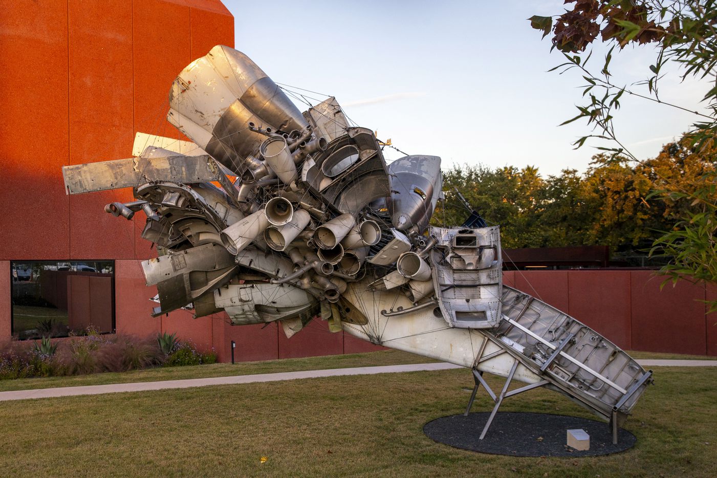 A Nancy Rubins sculpture made with mangled airplane parts is featured in the enclosed...