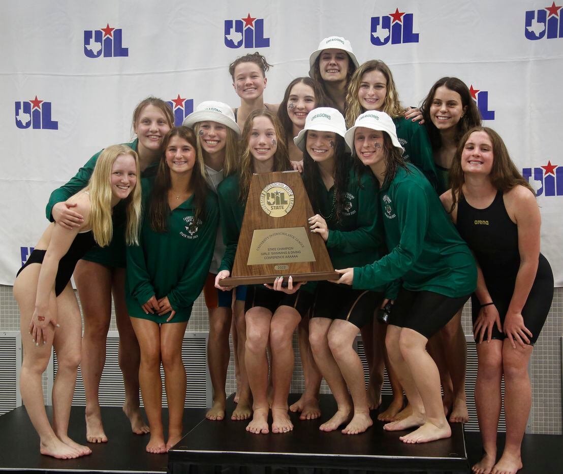 Members of the Southlake Carroll girls swim team pose with their trophy for capturing first...