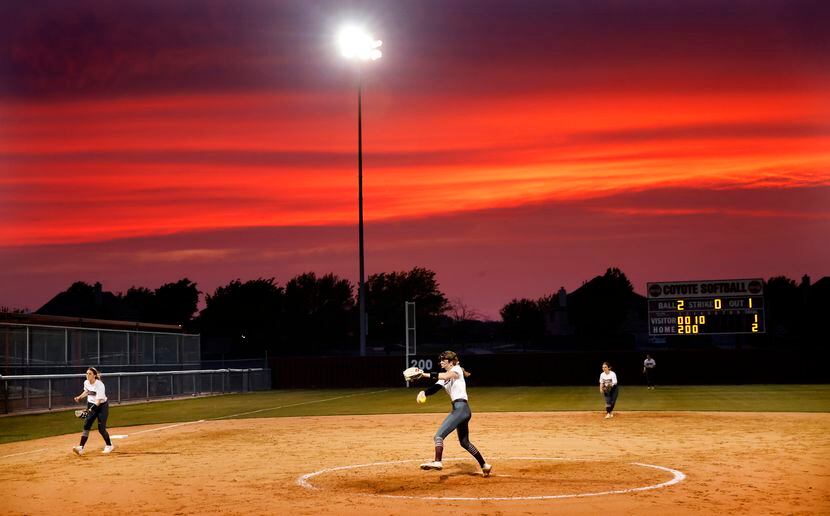 Before the setting sun, Frisco Heritage starting pitcher Jensin Hall throws a pitch to...