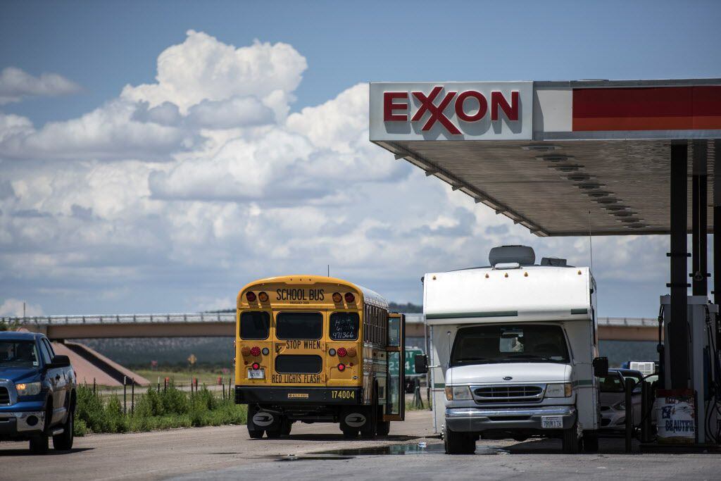 A school bus stops next to a roadside Exxon gas station outside Aurora, N.M. (File...