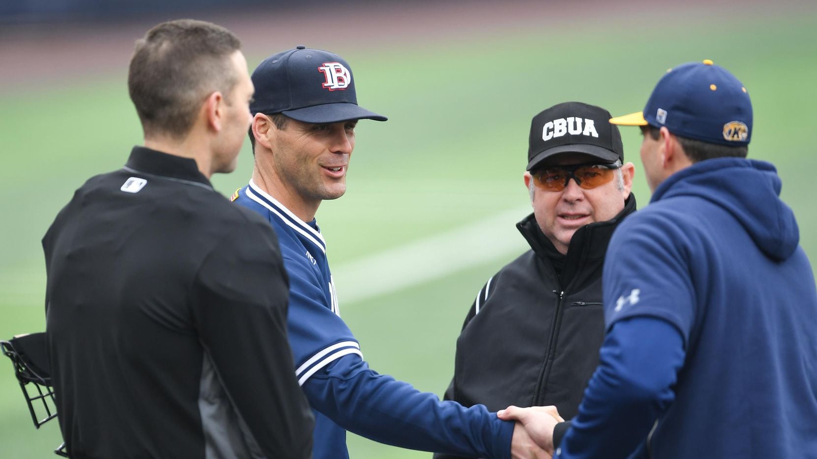 Dallas Baptist head coach Dan Heefner greets the opposing coach and umpires at home plate. The DBU season, along with the rest of college baseball, has been canceled this season due to concerns over the coronavirus. (Courtesy of DBU Athletics).