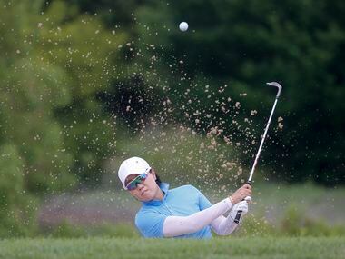 Professional golfer Jeongeun Lee plays out of the No. 9 fairway side bunker during the...