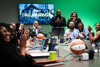 Dallas Wings President and CEO Greg Bibb (seated, facing), assistant general manager Travis...