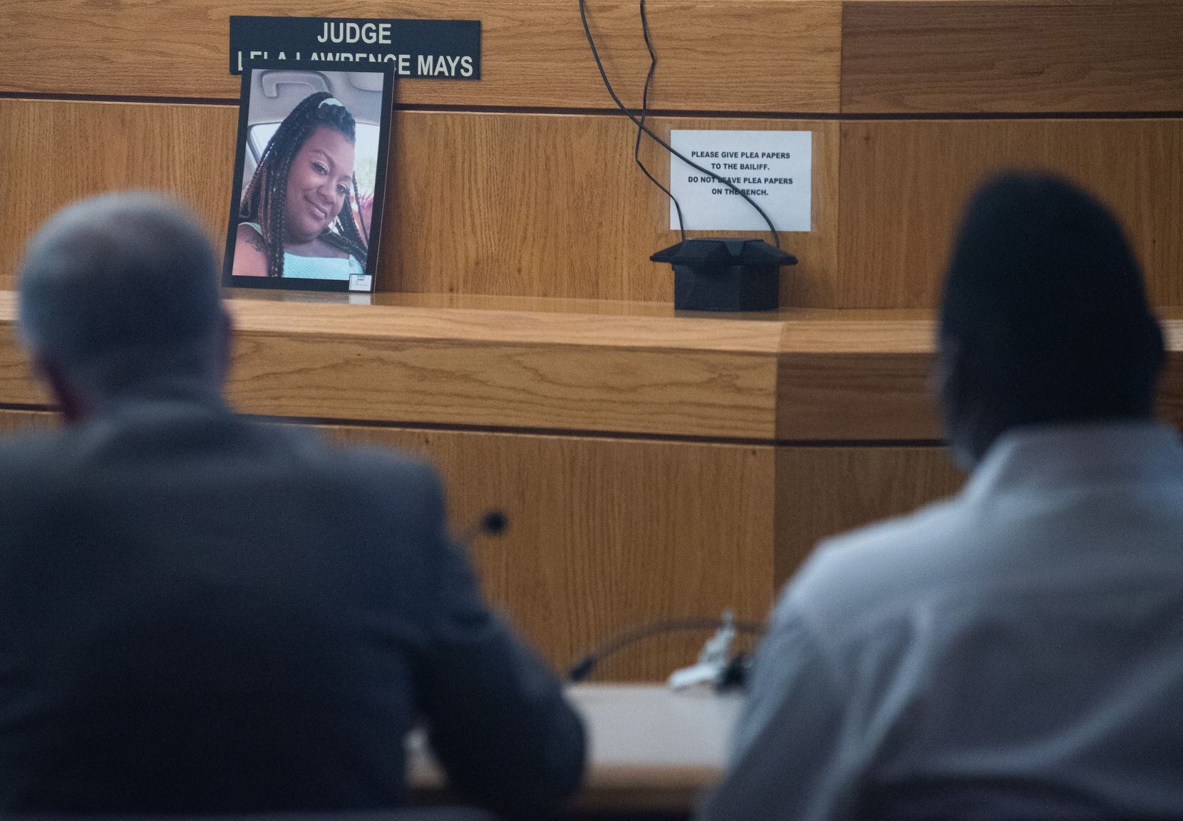 An image of Raesha Allison, 29, sat nearby as her husband, defendant Roger Allison (far...